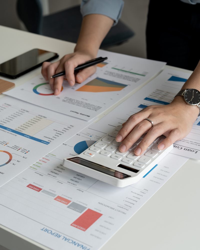Accoutant woman using calculator accounting financial budget and loan paper in office.