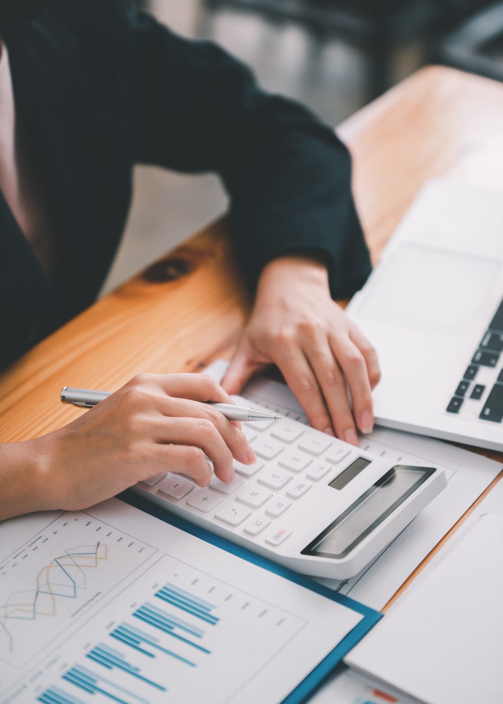 business woman or accountant who are using a calculator to calculate business data Accounting docume